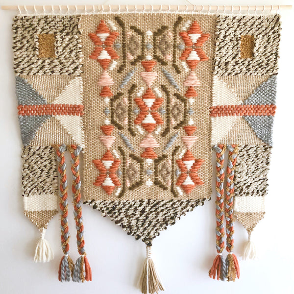 A beige tapestry with orange and white accents